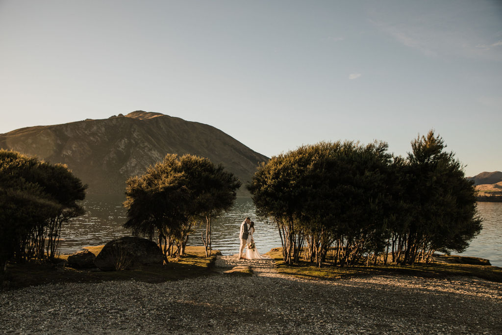 Bride and groom at golden hour by the lake - Wanaka Station Park Wedding Photography